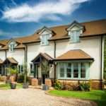 Residential property showcasing modern architecture and landscaped garden, photographed by Duncan MacBrayne, highlighting appealing features to attract potential guests.