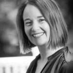 Nadine Young smiling in a professional portrait, showcasing her satisfaction with Duncan MacBrayne's photography services, emphasising a friendly and approachable demeanor.