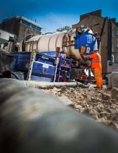 Construction worker operating industrial machinery at a site in Reading, showcasing commercial and industrial photography services by Duncan MacBrayne.