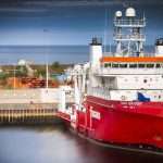 Red industrial ship docked at a harbour, showcasing marine photography by Duncan MacBrayne, commercial photographer in Reading, Berkshire.
