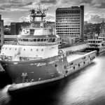 Industrial vessel docked in urban setting, showcasing maritime photography by Duncan MacBrayne, highlighting commercial and marine photography services in Reading, Berkshire.