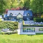 Luxury property with modern architecture, landscaped garden, and outdoor seating area, showcasing Duncan MacBrayne's commercial photography expertise in property imagery.