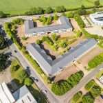 Aerial view of commercial property featuring landscaped grounds and modern buildings, highlighting Duncan MacBrayne's expertise in industrial and property photography in Reading, Berkshire.