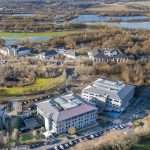 Aerial view of commercial and industrial buildings in Reading, Berkshire, showcasing property layout and surrounding landscape.