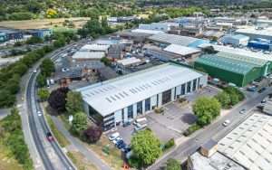 Aerial view of industrial buildings and warehouses in Reading, Berkshire, showcasing commercial property and surrounding landscape.
