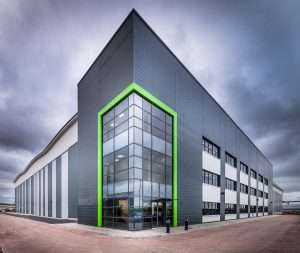 Modern commercial building with distinctive green accents, showcasing architectural design for industrial and corporate photography by Duncan MacBrayne in Reading, Berkshire.