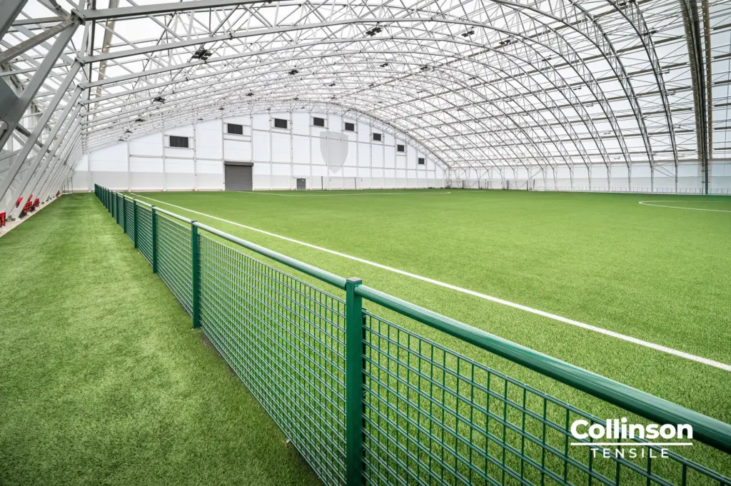 Collinson Tensile AFC Bournemouth Training Facility Dorset 009 Interior of the AFC Bournemouth indoor football training facility showing the full-size pitch and steel frame