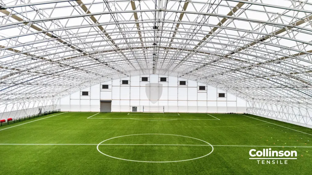 Collinson Tensile AFC Bournemouth Training Facility Interior Steel Frame - Duncan MacBrayne Interior construction photograph of the steel frame and tensile membrane roof inside the AFC Bournemouth training dome